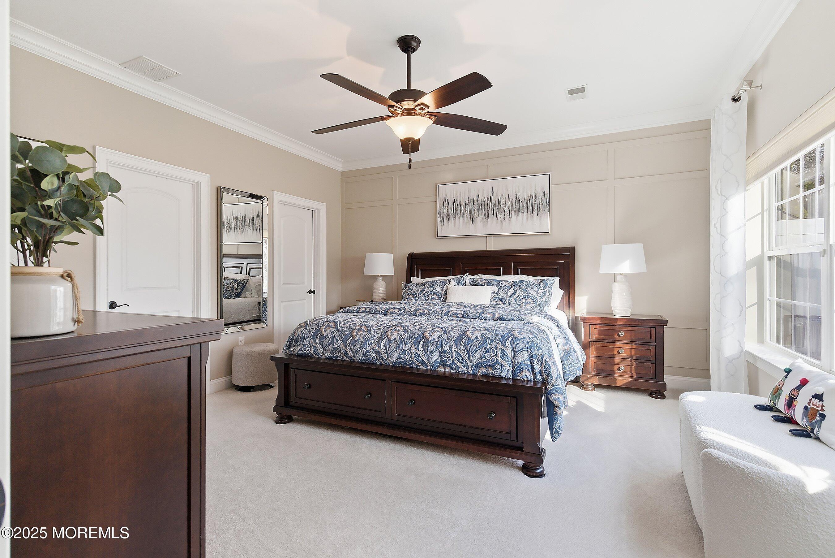 24 Abbey Road Tinton Falls, NJ 07753 - Photo 18 of 52 a bedroom with a large bed and a chandelier