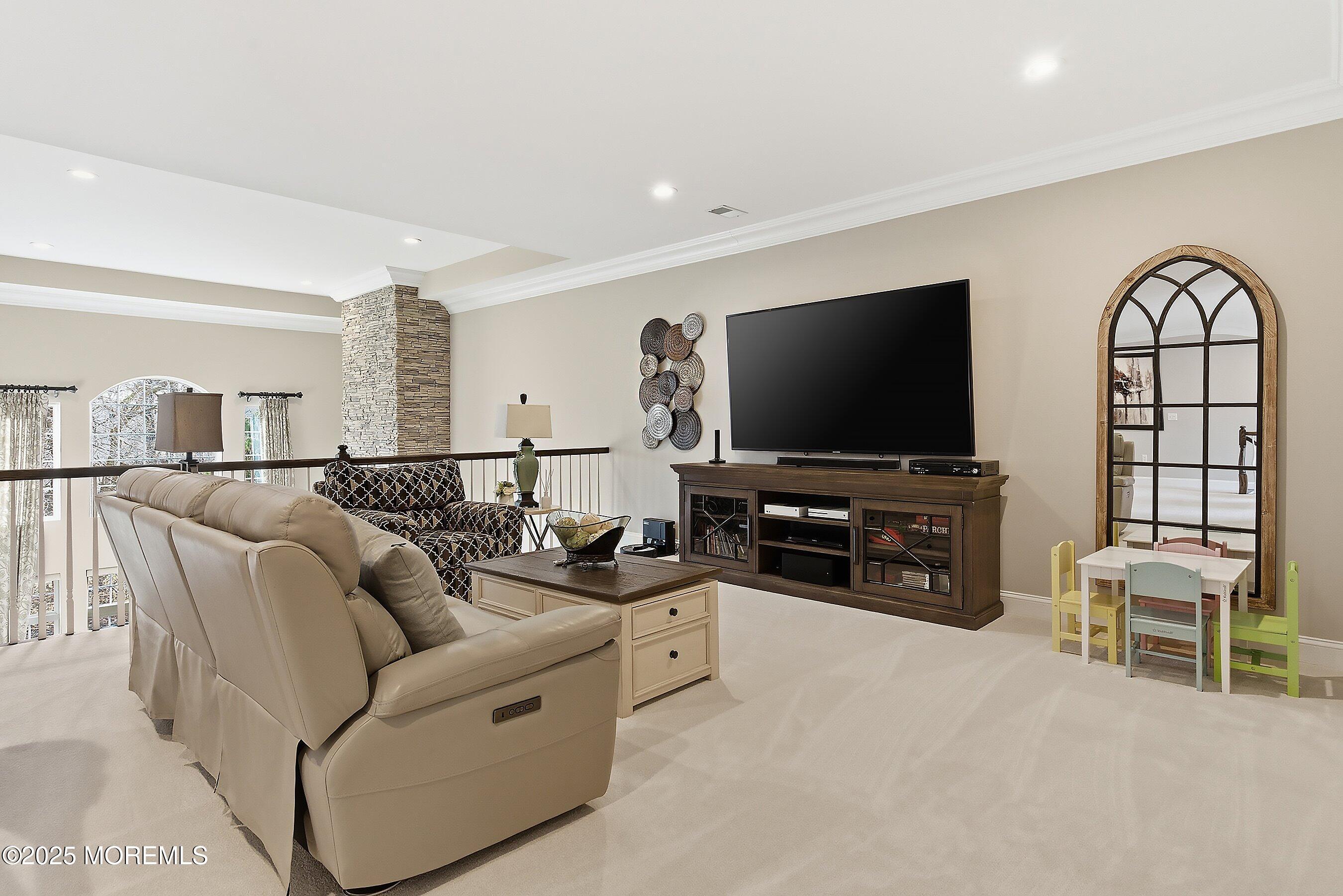 24 Abbey Road Tinton Falls, NJ 07753 - Photo 29 of 52 a living room with furniture and a flat screen tv