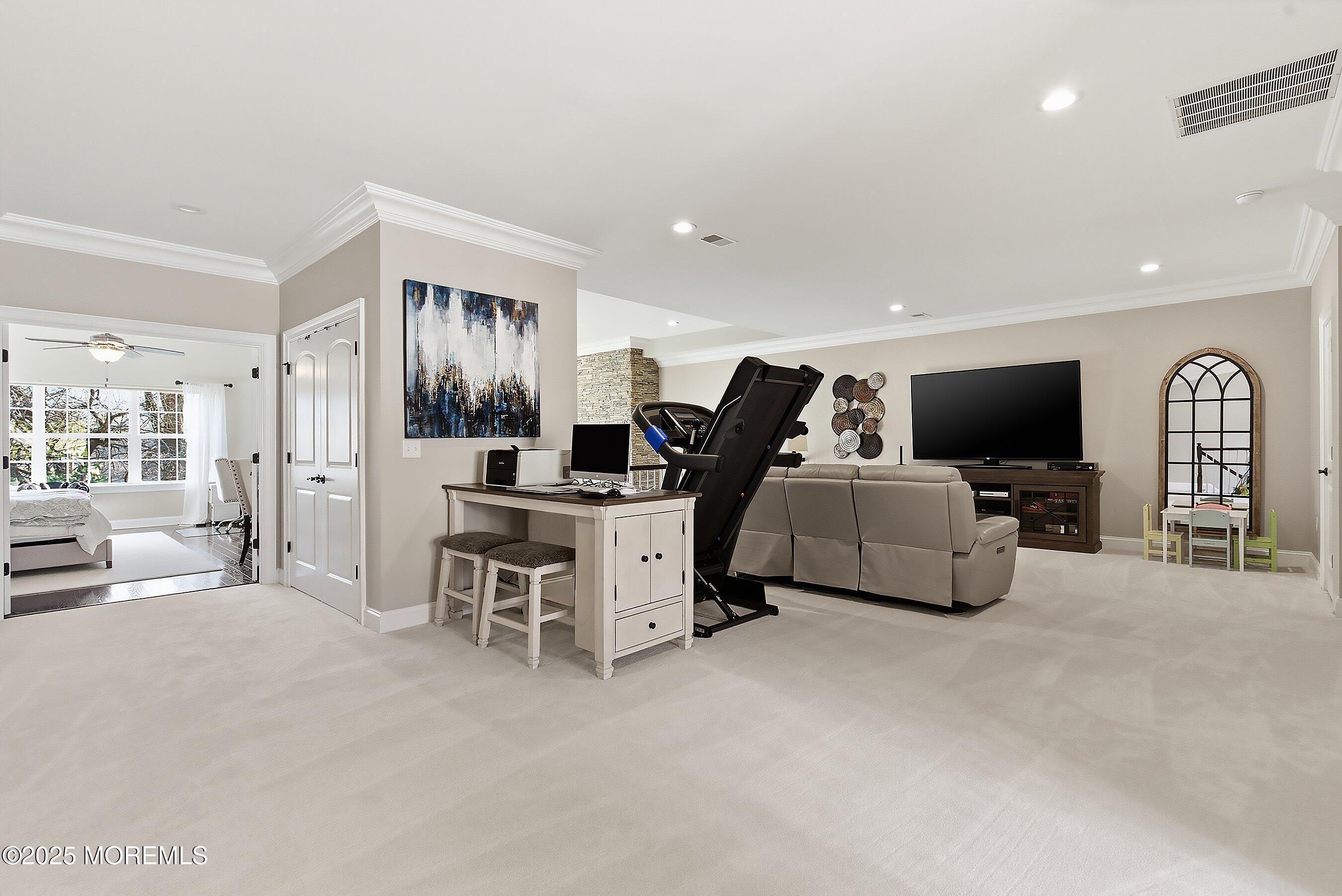 24 Abbey Road Tinton Falls, NJ 07753 - Photo 32 of 52 a living room with furniture and a flat screen tv