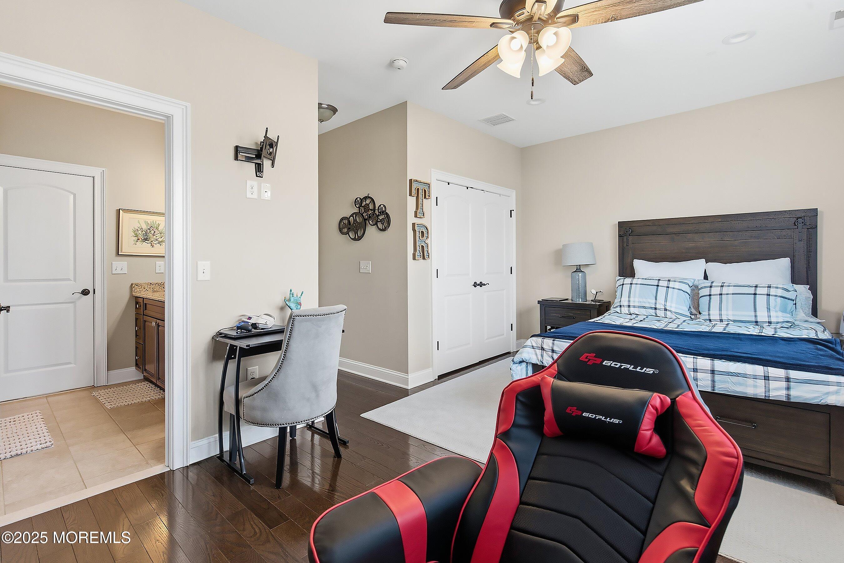 24 Abbey Road Tinton Falls, NJ 07753 - Photo 37 of 52 a bedroom with a bed and wooden floor