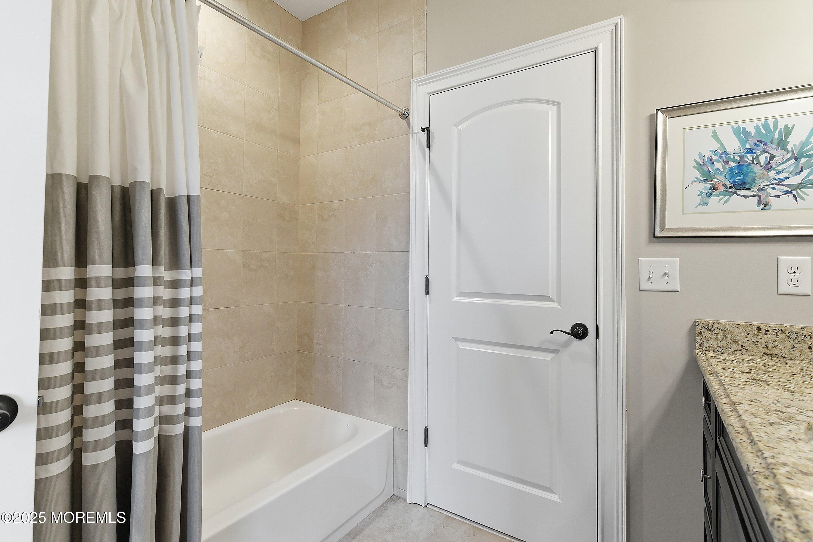 24 Abbey Road Tinton Falls, NJ 07753 - Photo 39 of 52 a bathroom with a shower and a tub