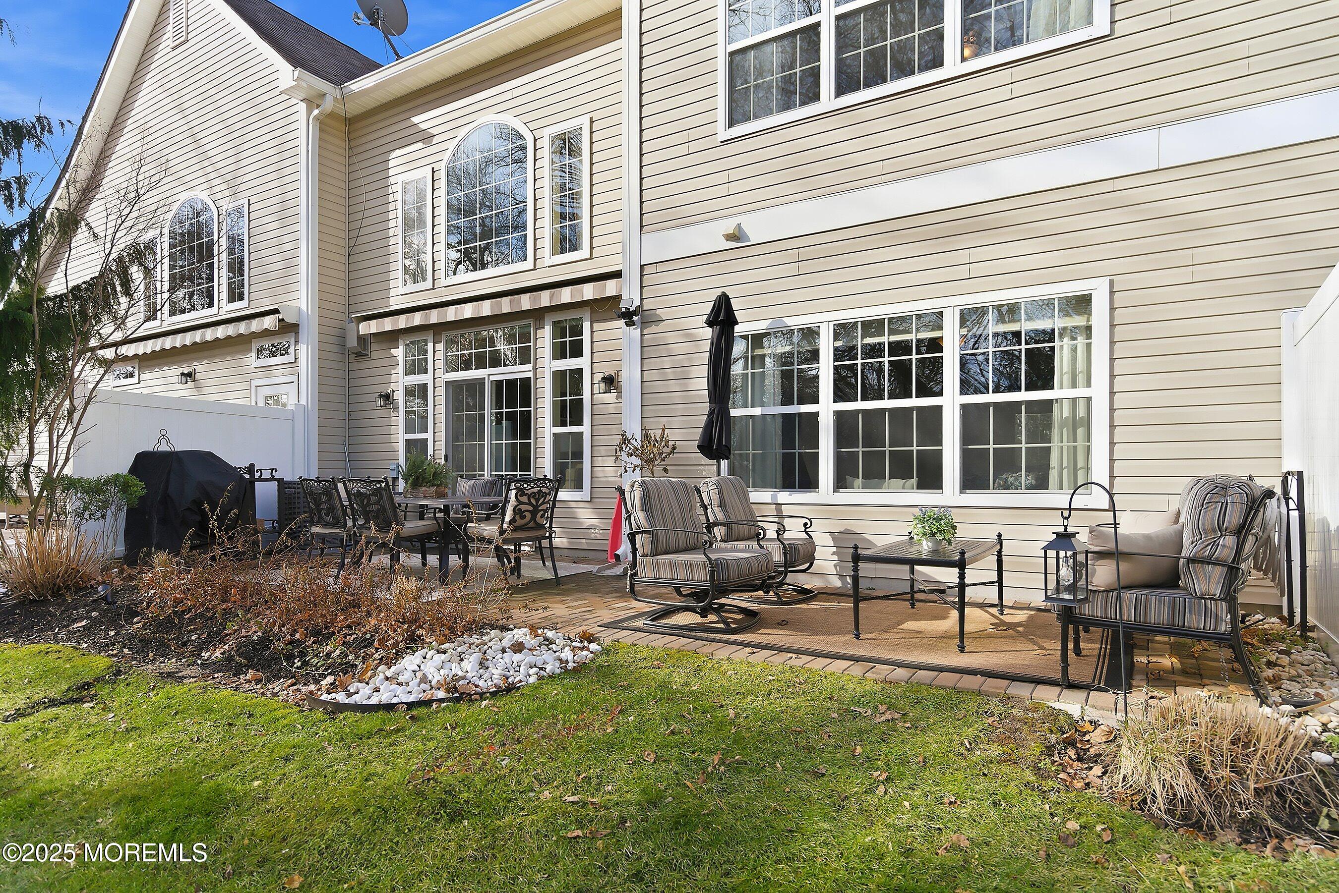 24 Abbey Road Tinton Falls, NJ 07753 - Photo 40 of 52 a view of a house with backyard porch and sitting area