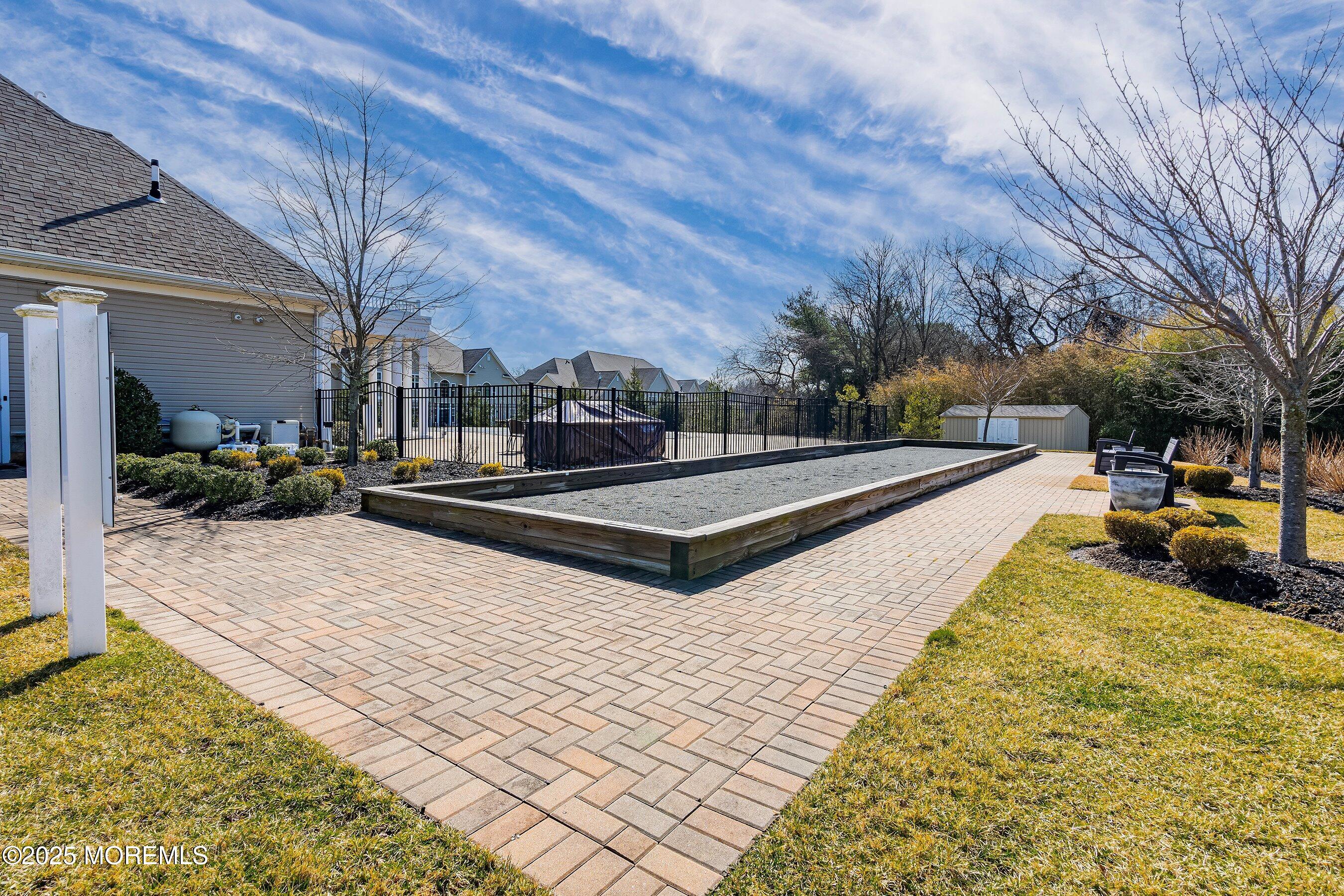 24 Abbey Road Tinton Falls, NJ 07753 - Photo 52 of 52 a view of swimming pool with lawn chairs and plants