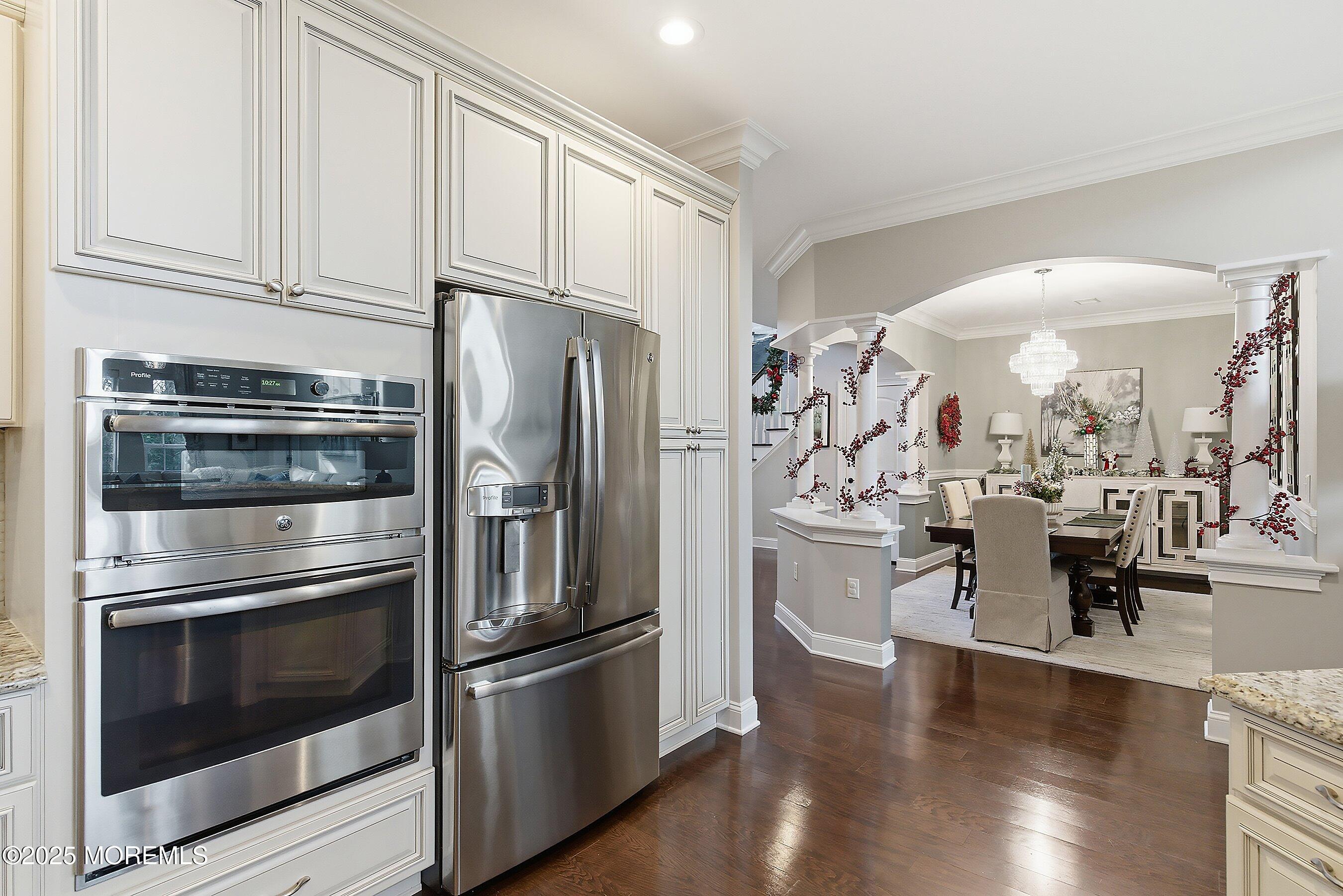 24 Abbey Road Tinton Falls, NJ 07753 - Photo 9 of 52 a kitchen with stainless steel appliances and wooden floor