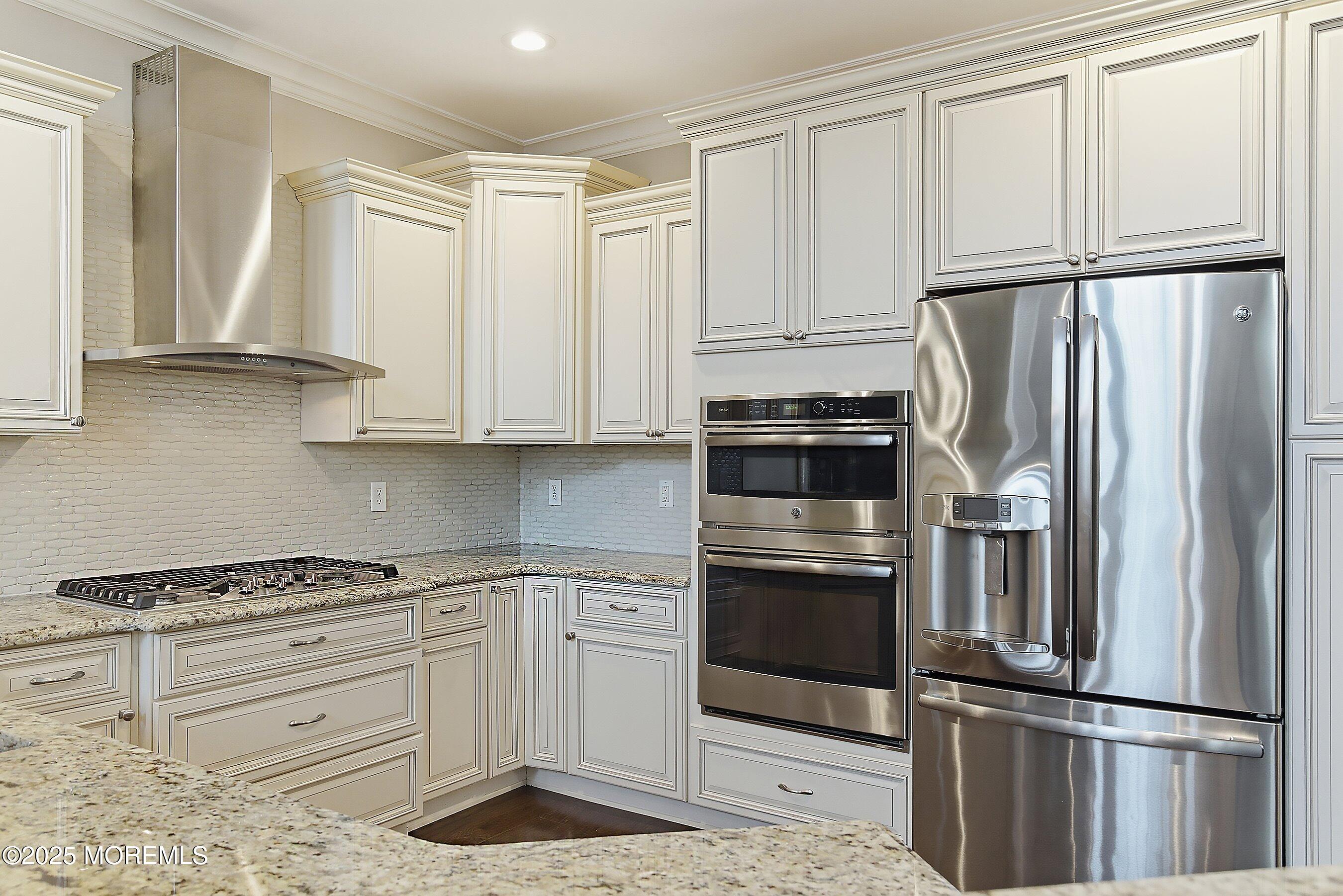 24 Abbey Road Tinton Falls, NJ 07753 - Photo 10 of 52 a kitchen with granite countertop white cabinets and stainless steel appliances
