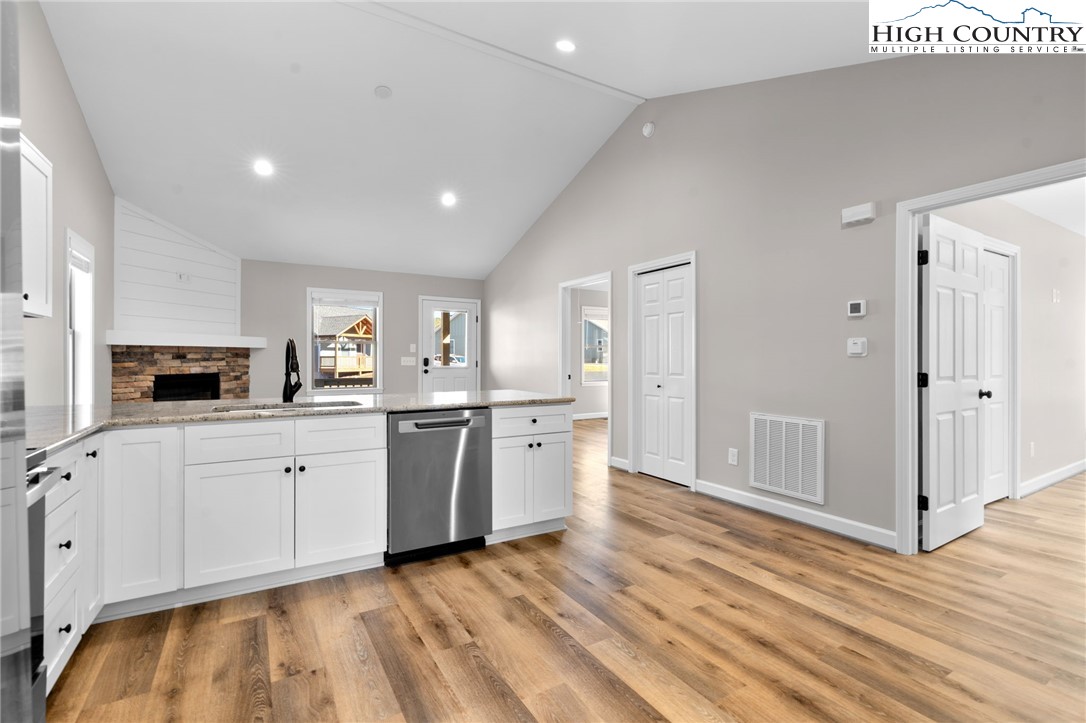 233 Ava Way, Unit 109 Boone, NC 28607 - Photo 12 of 26 a kitchen with a sink cabinets stainless steel appliances and wooden floor
