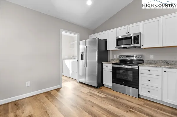 a kitchen with stainless steel appliances a refrigerator stove and microwave