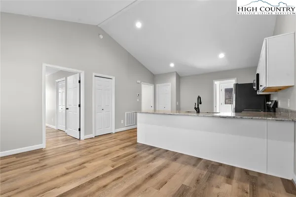 a view of kitchen with stainless steel appliances refrigerator oven and cabinets