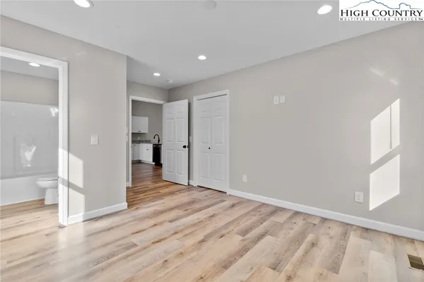 a view of empty room with wooden floor