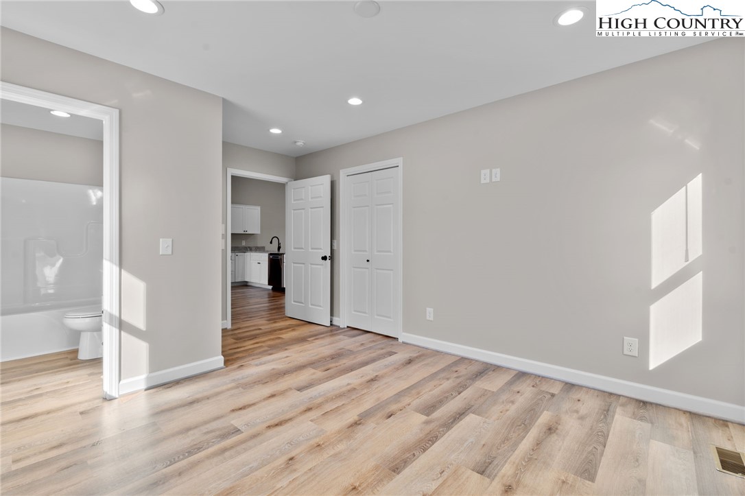 233 Ava Way, Unit 109 Boone, NC 28607 - Photo 15 of 26 a view of empty room with wooden floor