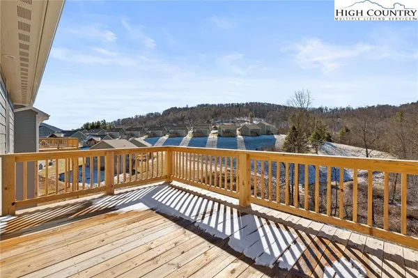 a view of balcony with wooden floor and fence