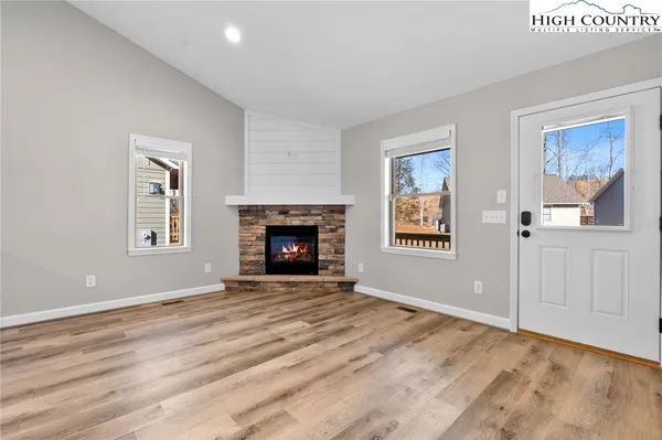 a view of empty room with windows and fireplace