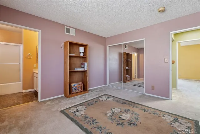 a view of an empty room with a fireplace