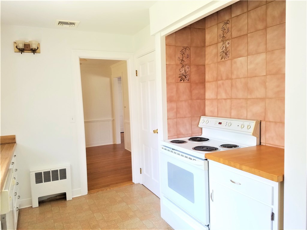 142 Naushon Road Pawtucket, RI 02861 - Photo 18 of 26 The kitchen leads into what could be the dining room or breakfast area.