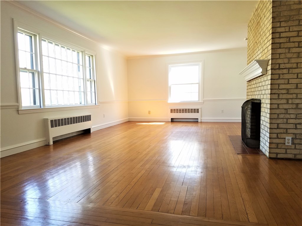 142 Naushon Road Pawtucket, RI 02861 - Photo 8 of 26 Over-sized living room with lots of light, fireplace and beautiful hardwood floors; could be a living/dining room, it's large enough!