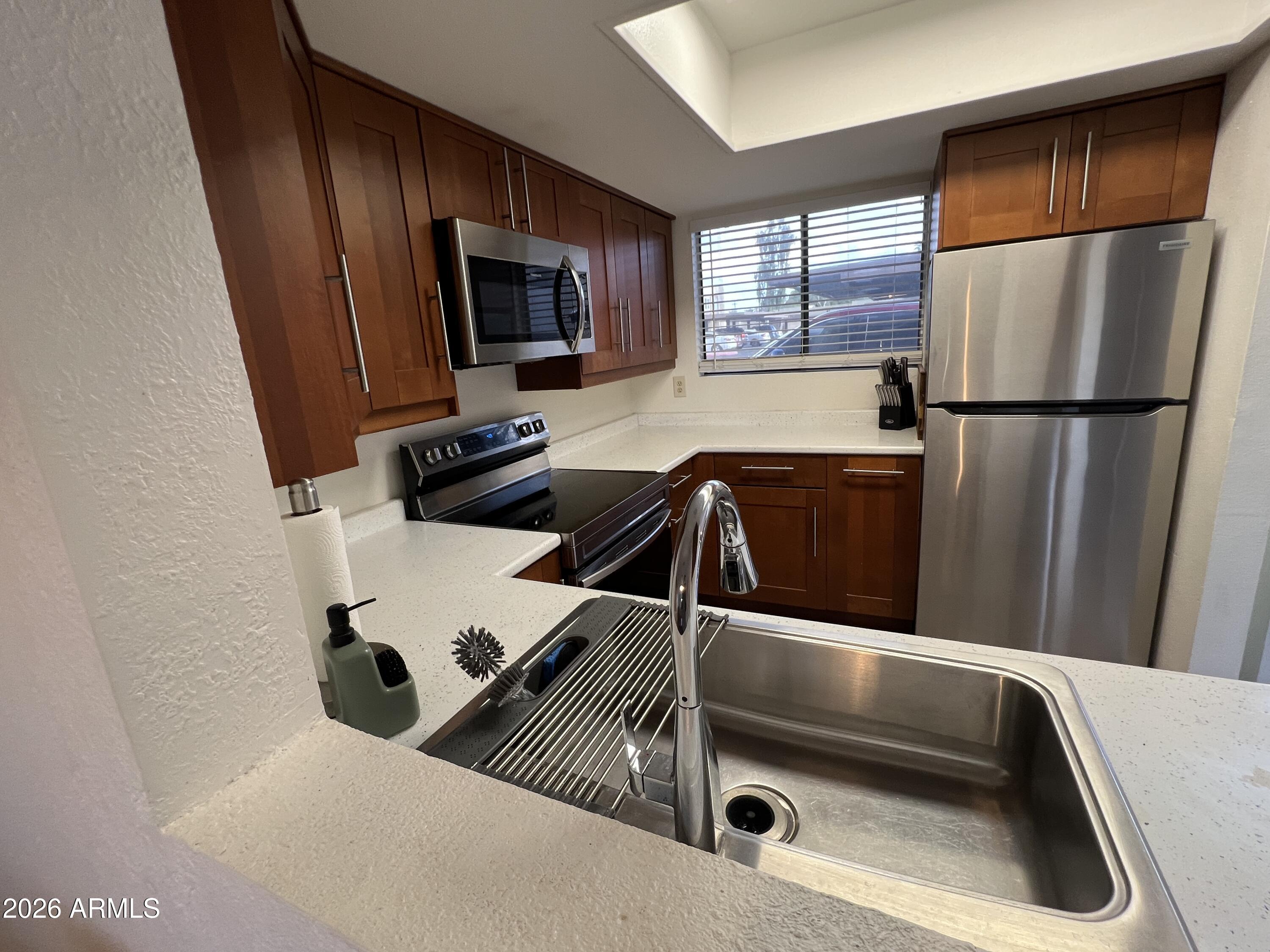 617 West 13th Street Tempe, AZ 85281 - Photo 12 of 23 a kitchen with a refrigerator and a sink