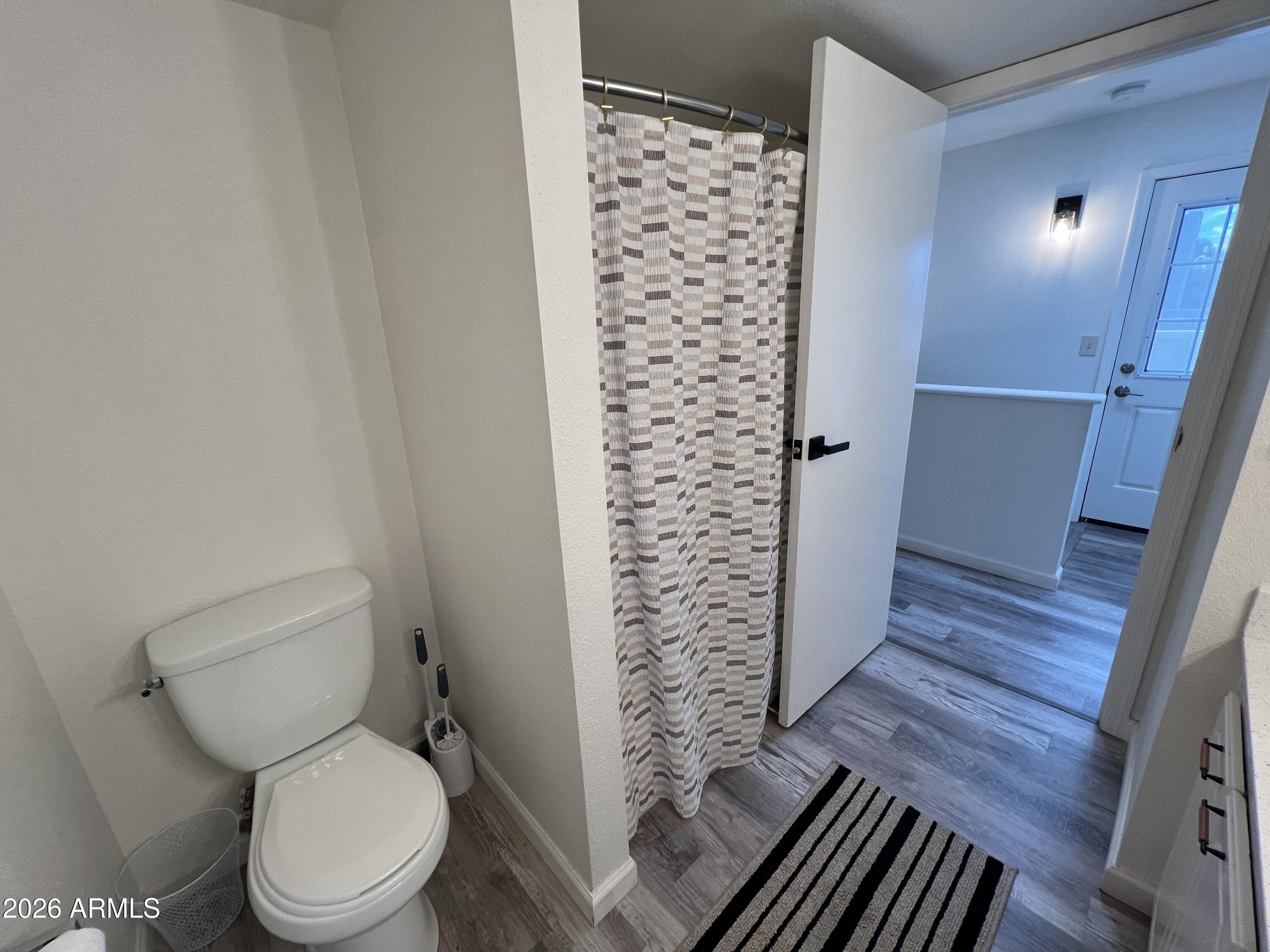 617 West 13th Street Tempe, AZ 85281 - Photo 21 of 23 a white toilet sitting next to a shower curtain