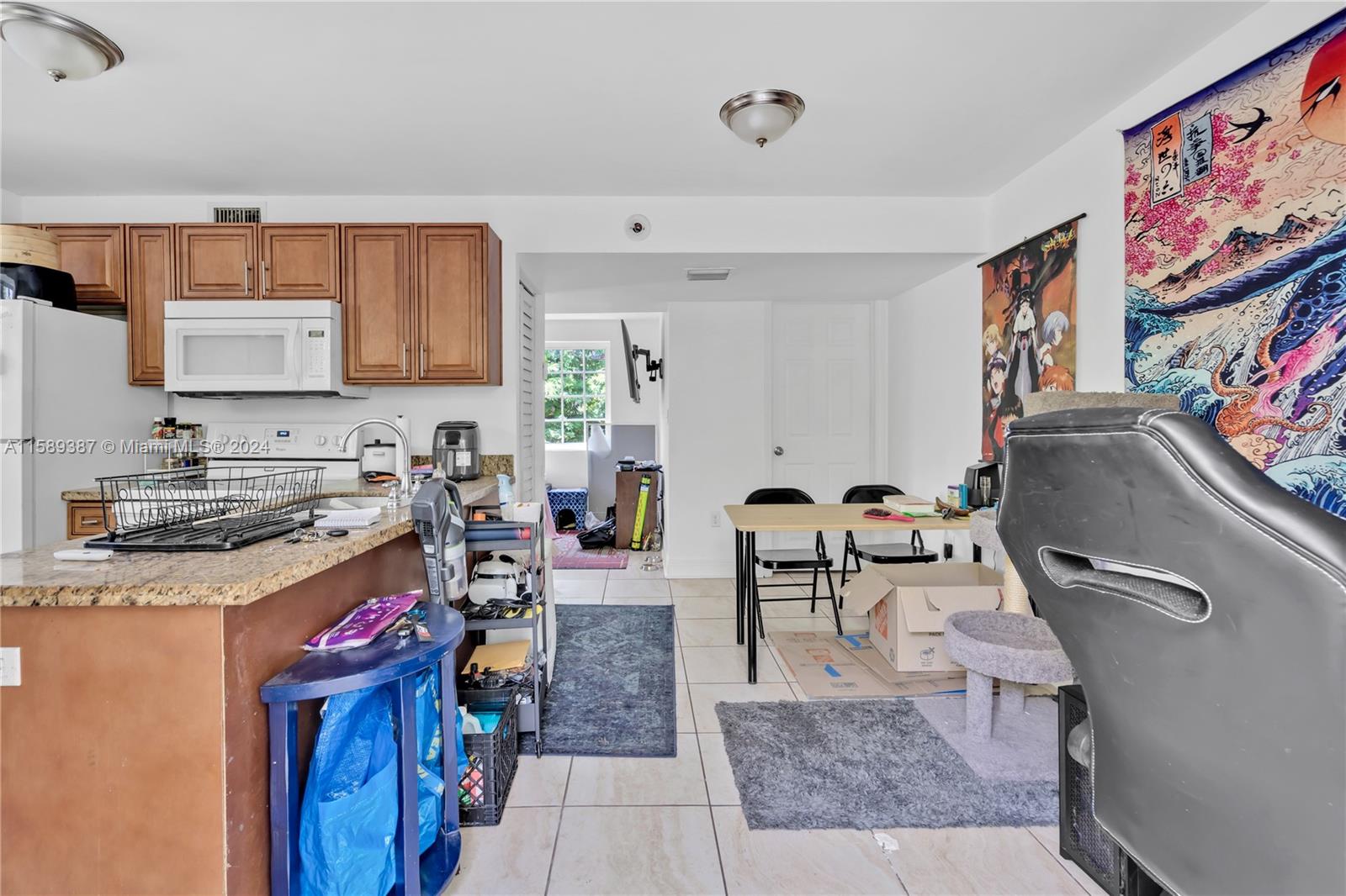 210 Northwest 16th Street Miami, FL 33136 - Photo 15 of 29 a kitchen with stainless steel appliances granite countertop a stove top oven a sink dishwasher and cabinets with wooden floor