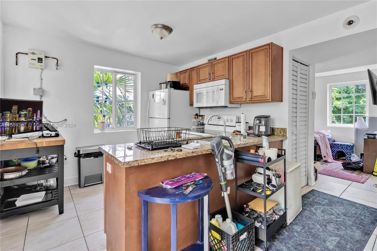 210 Northwest 16th Street Miami, FL 33136 - Photo 16 of 29 a kitchen that has a lot of cabinets in it and a window