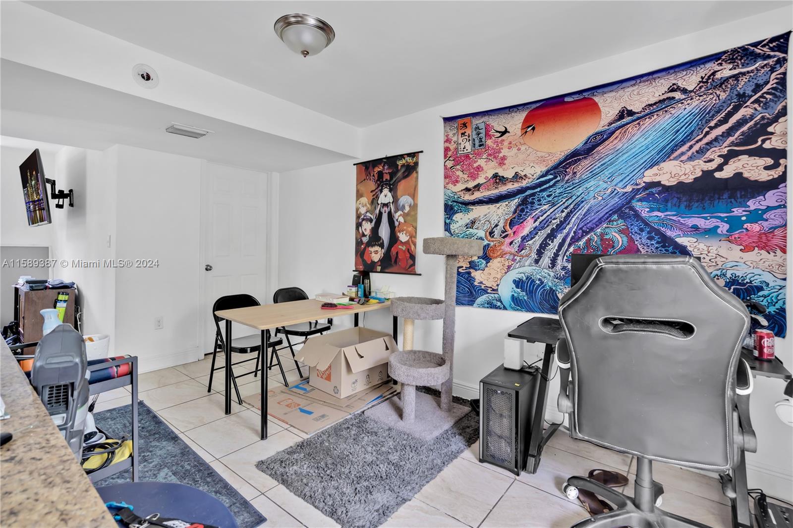 210 Northwest 16th Street Miami, FL 33136 - Photo 17 of 29 a living room with furniture and a flat screen tv
