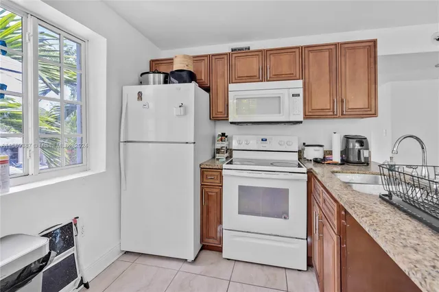 a kitchen with a refrigerator stove and sink
