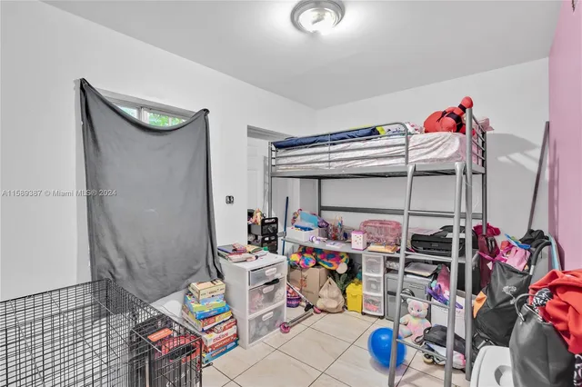 a bed room with a bed and a chair