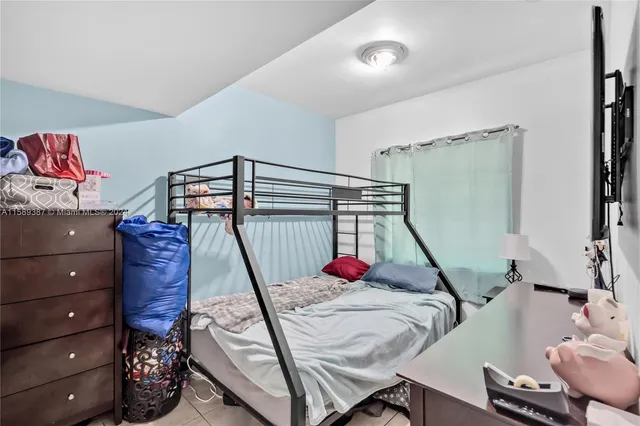 a bathroom with a granite countertop sink mirror vanity and toilet