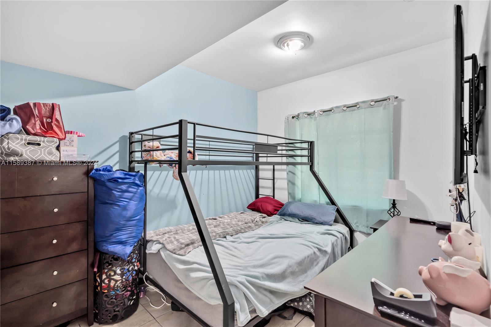 210 Northwest 16th Street Miami, FL 33136 - Photo 28 of 29 a bed room with a bed and a chair