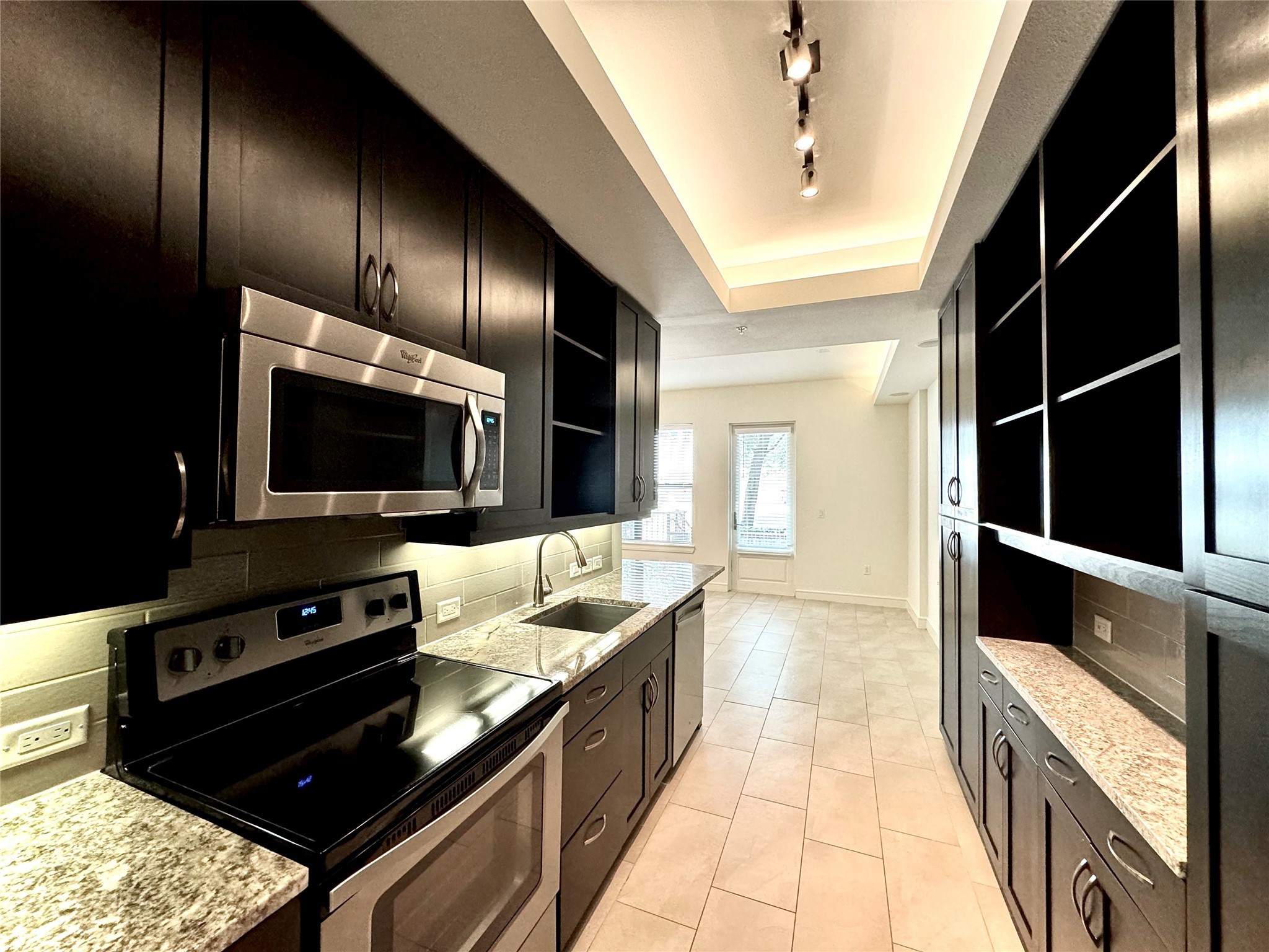 a kitchen with granite countertop stainless steel appliances and wooden cabinets