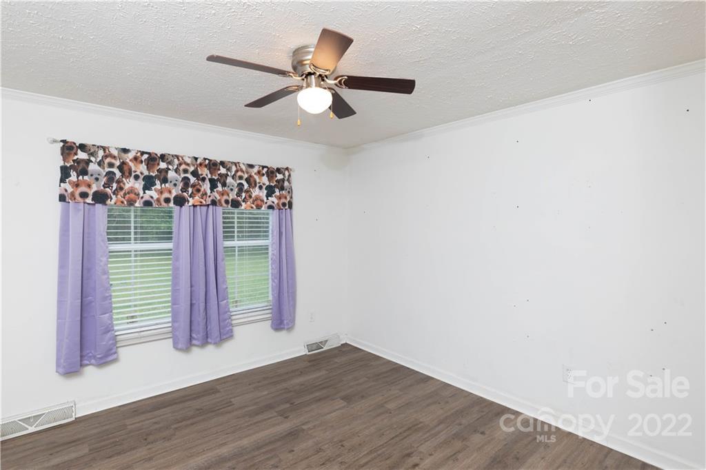 265 Whiteside Road Clover, SC 29710 - Photo 15 of 47 an empty room with wooden floor fan and windows