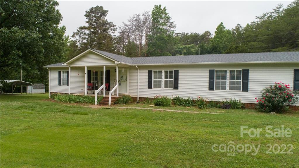 265 Whiteside Road Clover, SC 29710 - Photo 18 of 47 a front view of a house with a garden