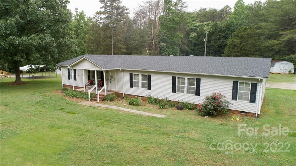 265 Whiteside Road Clover, SC 29710 - Photo 25 of 47 a aerial view of a house with table and chairs under an umbrella