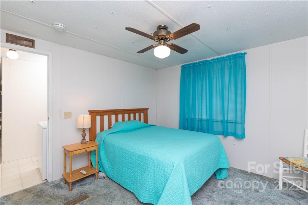 265 Whiteside Road Clover, SC 29710 - Photo 38 of 47 a bedroom with a bed and a chandelier