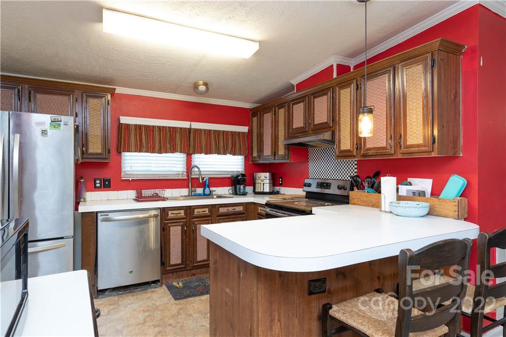 265 Whiteside Road Clover, SC 29710 - Photo 6 of 47 a kitchen with stainless steel appliances a sink a stove a refrigerator and cabinets