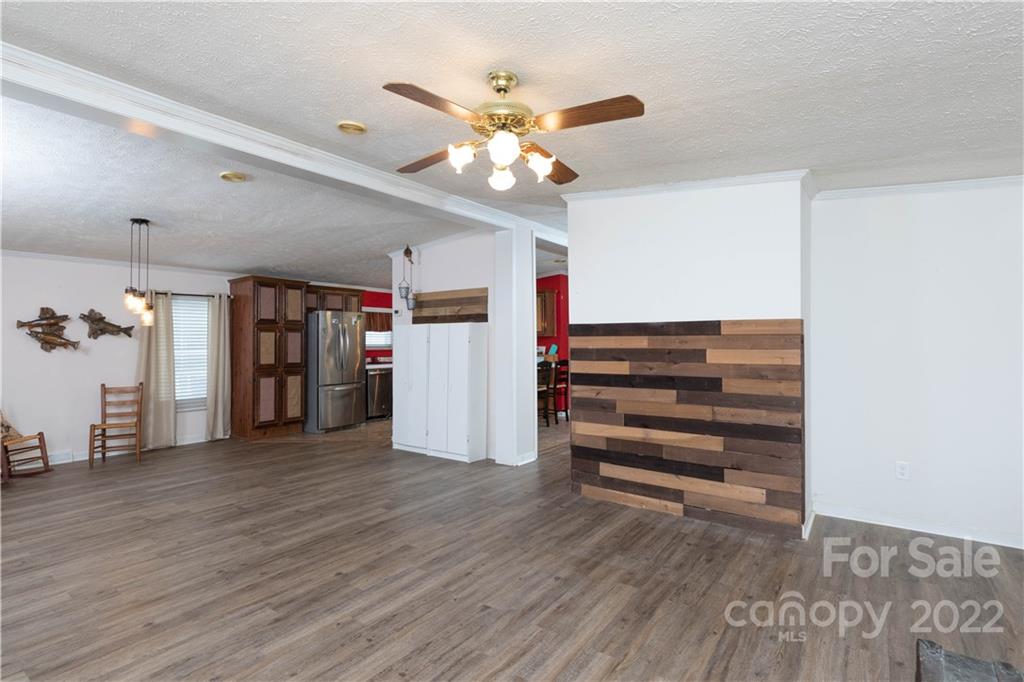 265 Whiteside Road Clover, SC 29710 - Photo 8 of 47 a view of an empty room with wooden floor and a ceiling fan