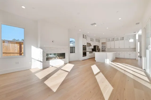 a large white kitchen with a large window