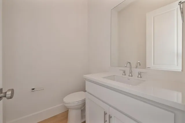 a bathroom with a sink a toilet and mirror
