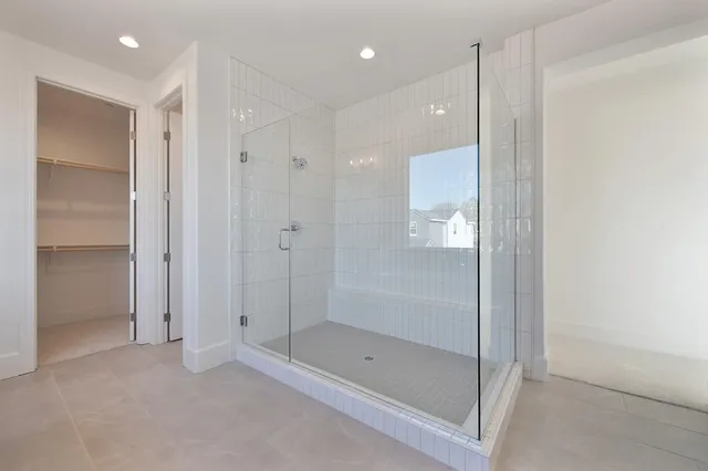 a bathroom with a shower and a glass door