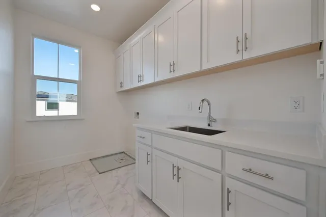 a kitchen with a sink and cabinets