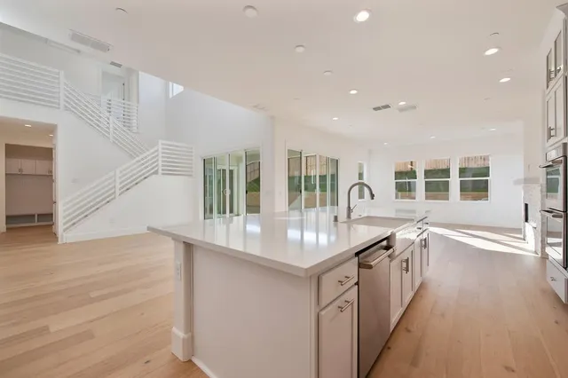 a kitchen with counter top space and windows