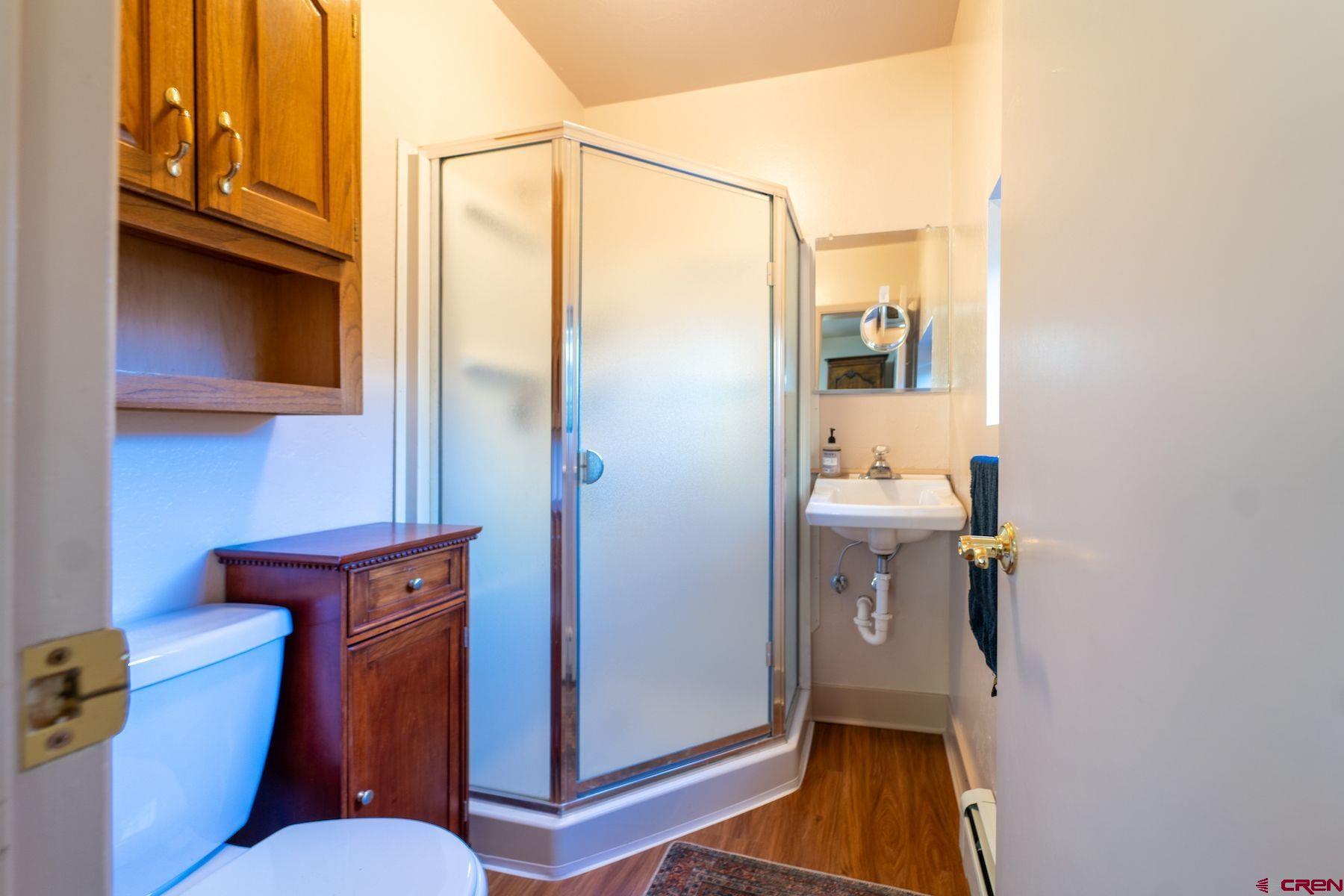 3649 Main Avenue Durango, CO 81301 - Photo 14 of 30 a bathroom with a toilet a sink and mirror
