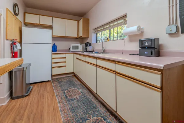 a kitchen with a refrigerator and a sink