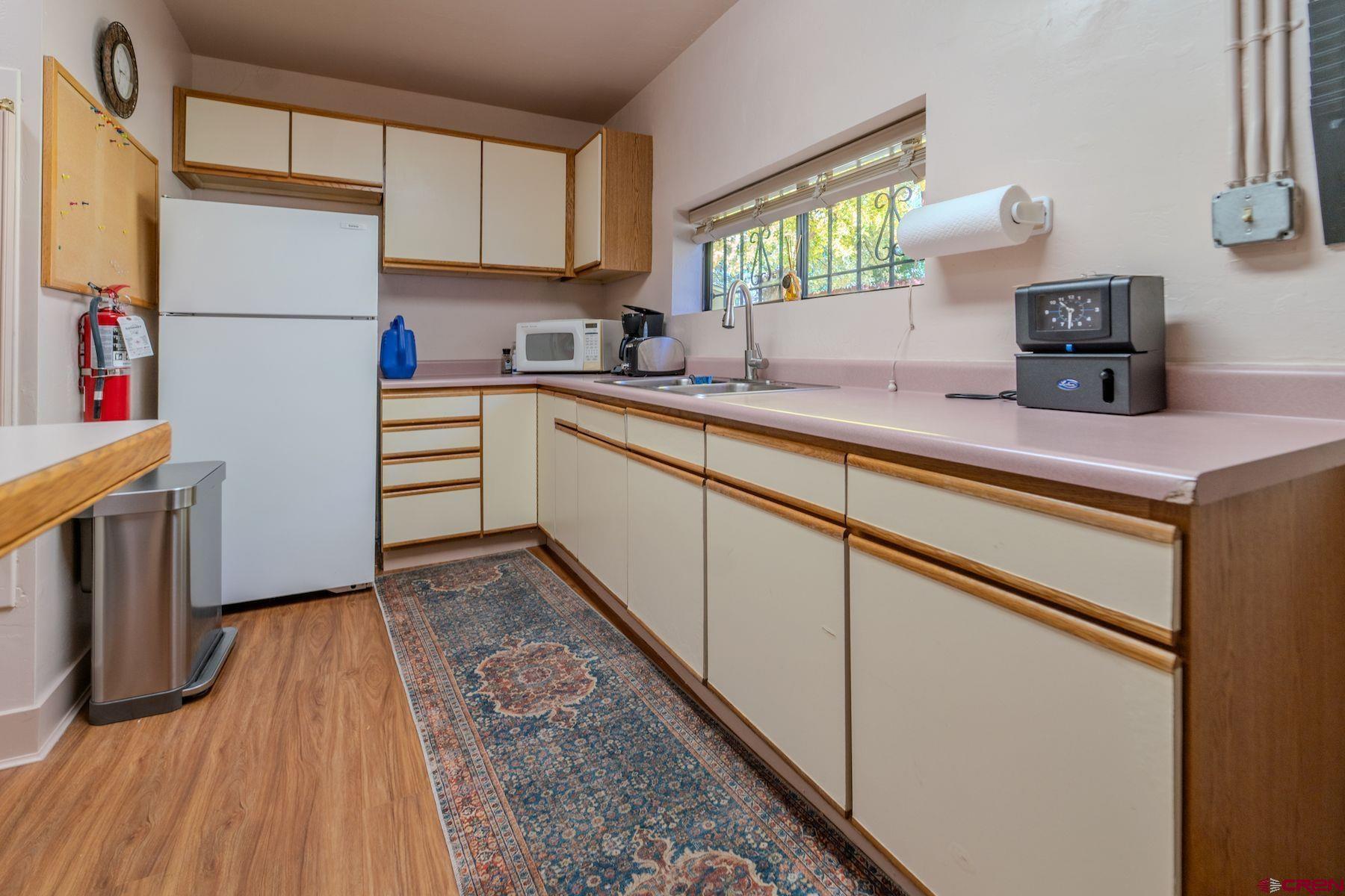 3649 Main Avenue Durango, CO 81301 - Photo 25 of 30 a kitchen with a refrigerator and a sink