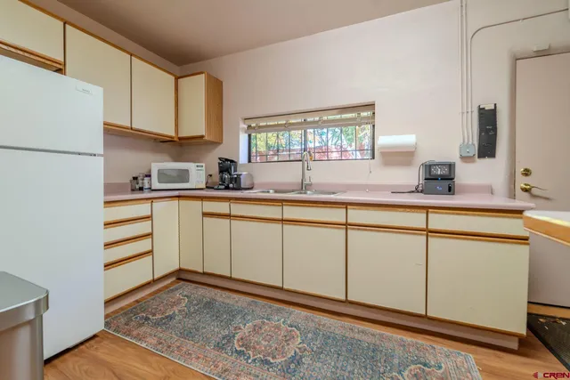 a kitchen with a sink cabinets and window