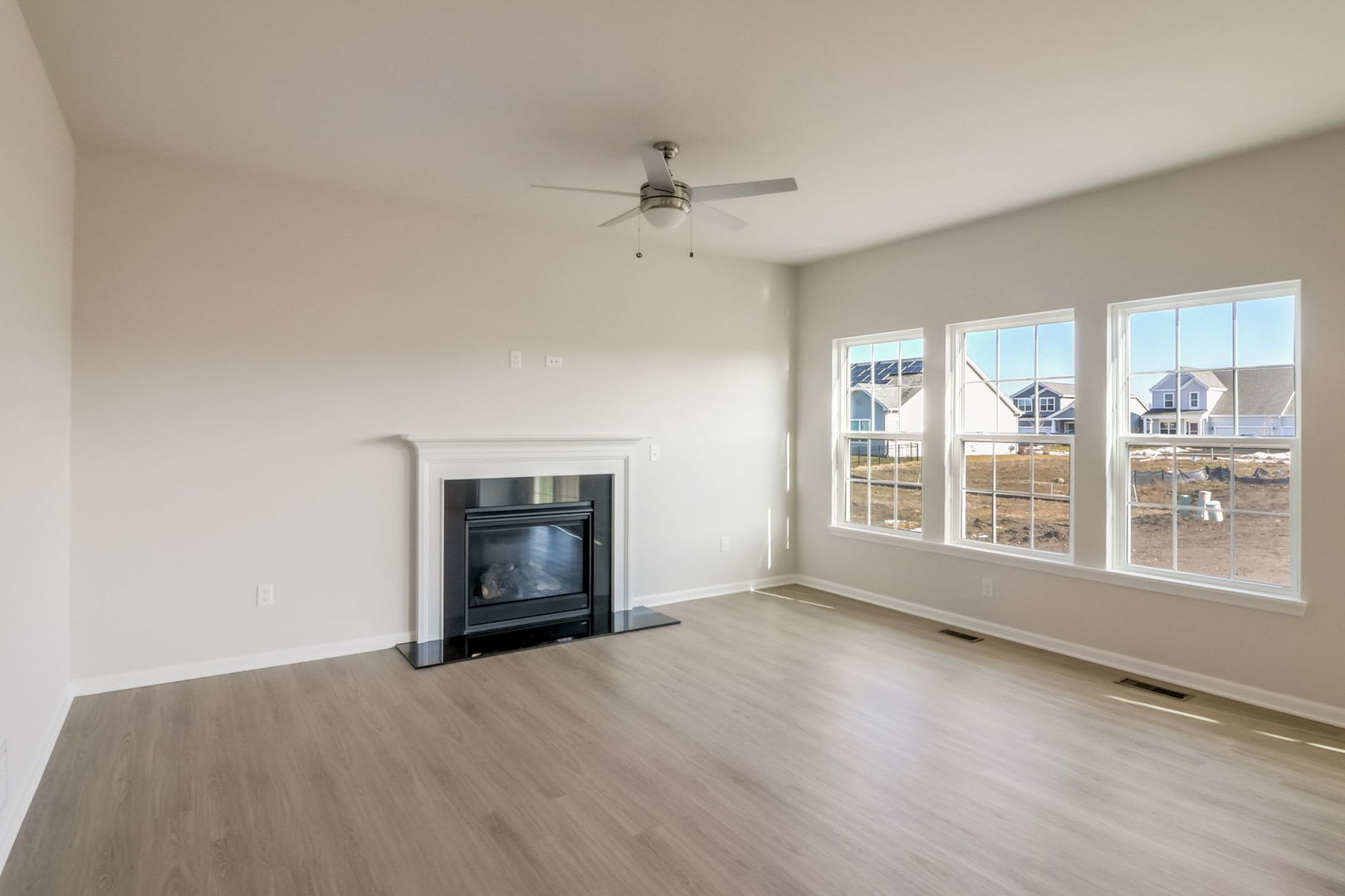 715 Maplewood Circle Elburn, IL 60119 - Photo 11 of 32 an empty room with windows and fireplace