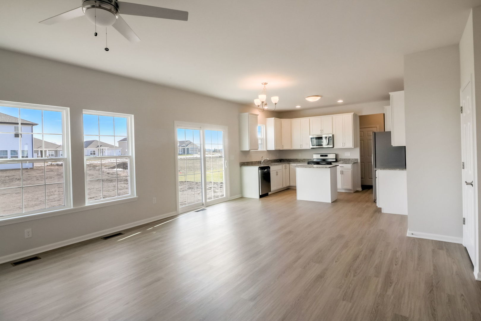 715 Maplewood Circle Elburn, IL 60119 - Photo 12 of 32 a large kitchen with cabinets wooden floor and a stainless steel appliances