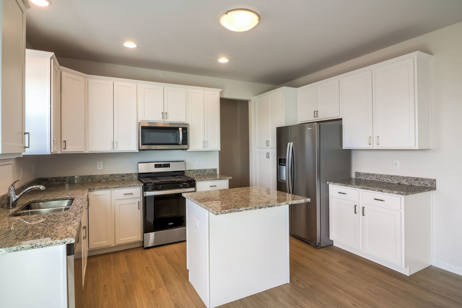 715 Maplewood Circle Elburn, IL 60119 - Photo 14 of 32 a kitchen with granite countertop a stove a sink and a refrigerator