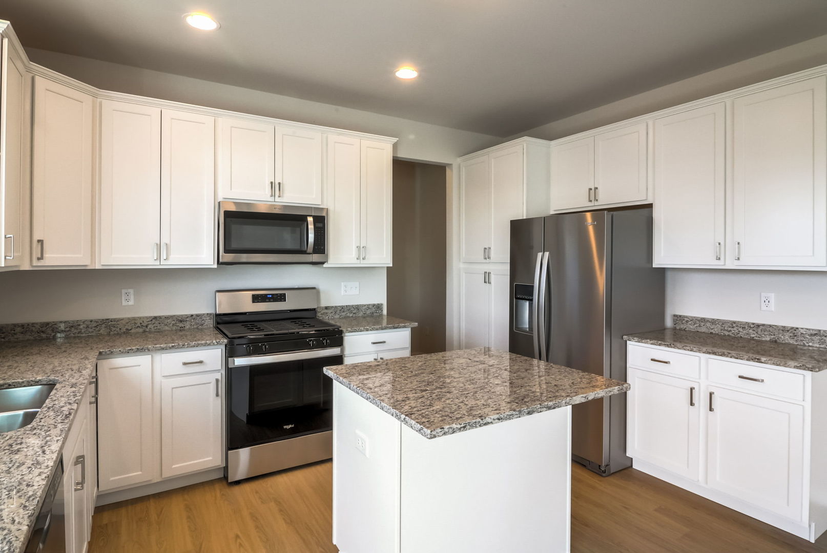 715 Maplewood Circle Elburn, IL 60119 - Photo 16 of 32 a kitchen with granite countertop white cabinets and stainless steel appliances