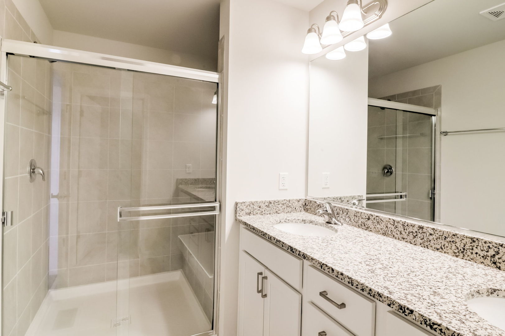 715 Maplewood Circle Elburn, IL 60119 - Photo 21 of 32 a bathroom with a granite countertop sink a mirror and a shower