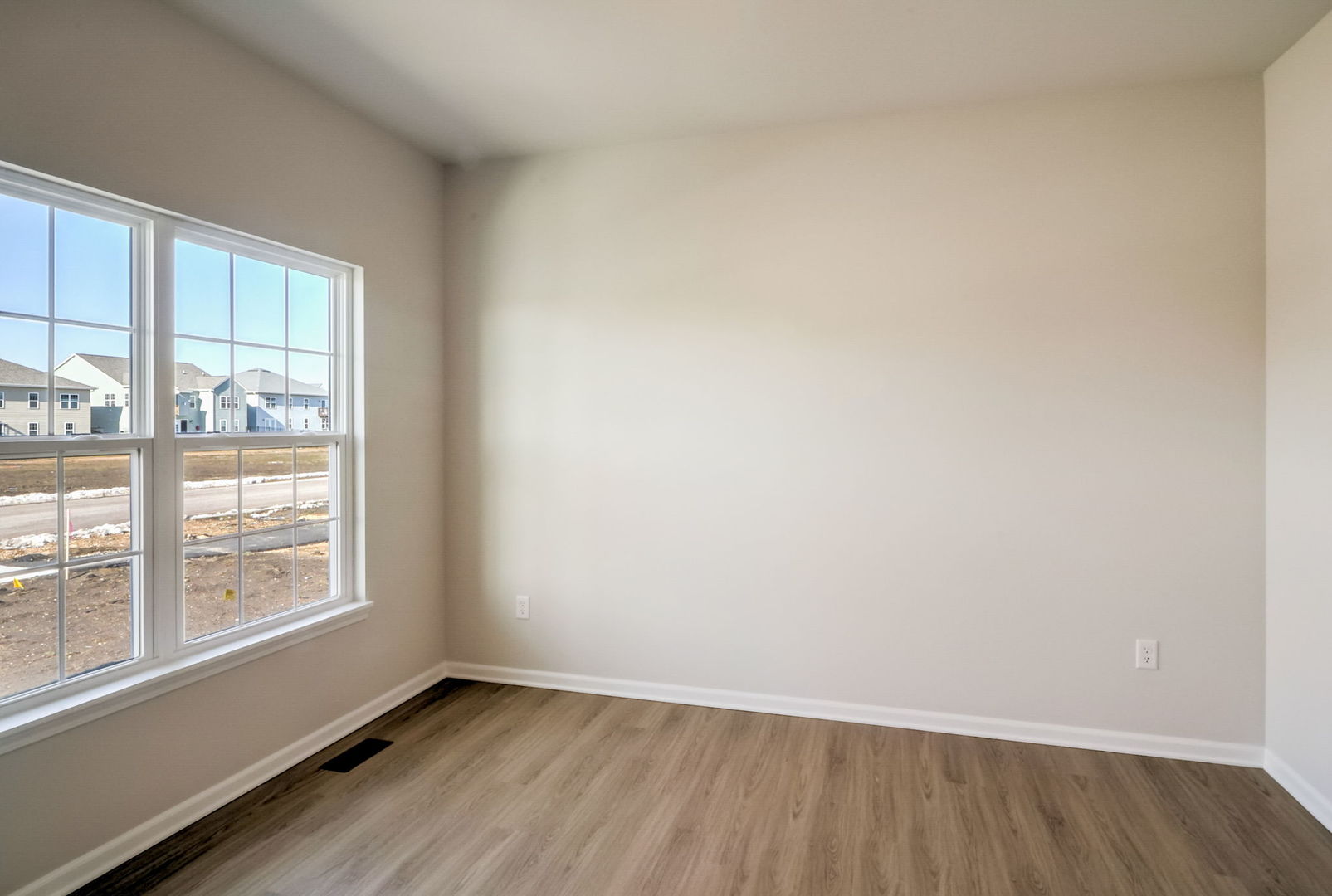 715 Maplewood Circle Elburn, IL 60119 - Photo 10 of 32 an empty room with wooden floor and windows